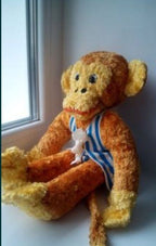 Soviet plush toy monkey in a blue and white striped telnyashka outfit
