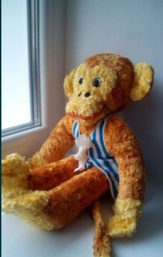Soviet plush toy monkey in a blue and white striped telnyashka outfit