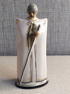 Soviet porcelain figurine of a Caucasian Djigit in a burka and tall hat with gold accents