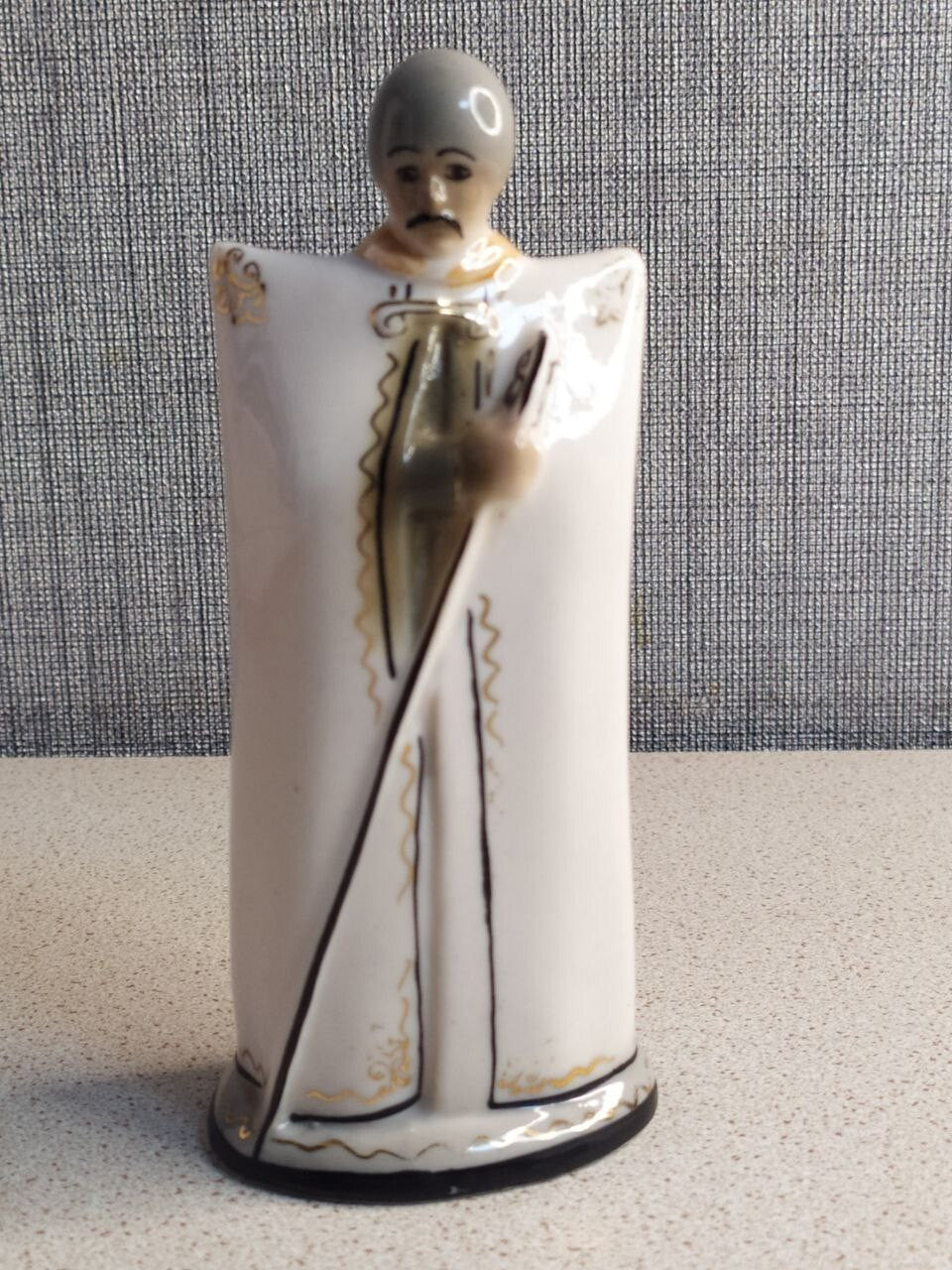 Soviet porcelain figurine of a Caucasian Djigit in a burka and tall hat with gold accents