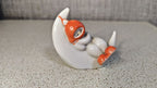 Soviet porcelain figurine of a sleeping child on a crescent moon from Polonne