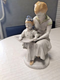 Soviet porcelain figurine of a mother and daughter reading a book together