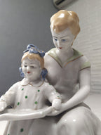 Mother and child reading porcelain figure, front view