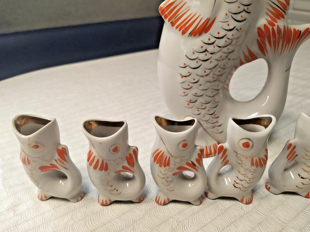 Six small Soviet fish shot glasses in orange and gold