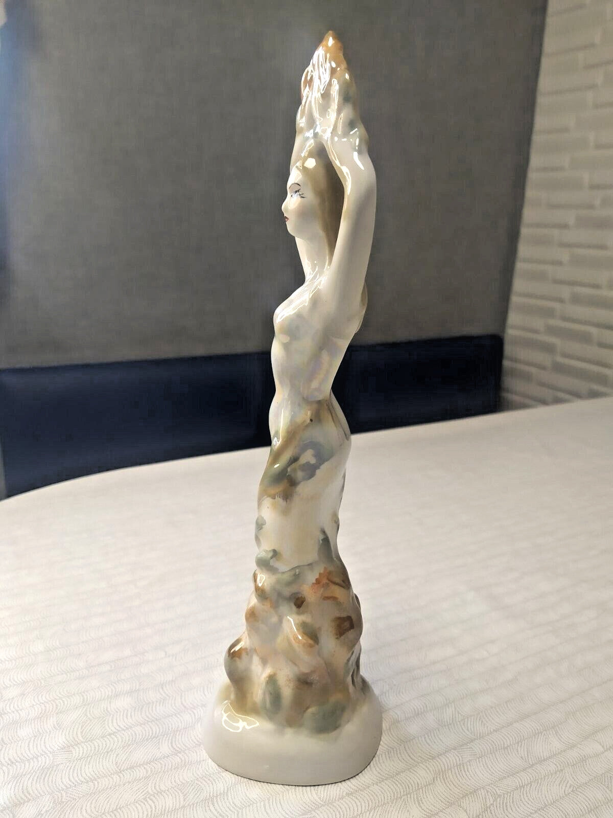 Ural folklore figurine with pearlescent glaze and rocky base