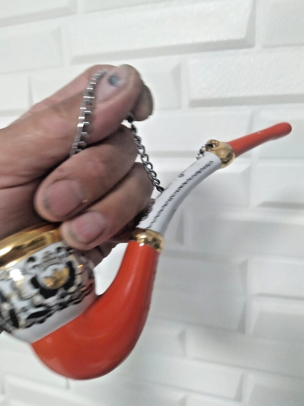 Decorative porcelain pipe with red and black flowers and hanging chain