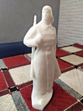 Soviet Red Army soldier figurine in budenovka cap and overcoat with rifle
