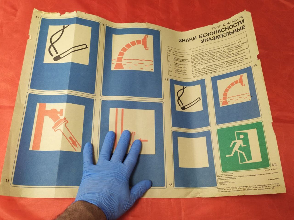 Torn top edge and fold lines on the Soviet safety poster