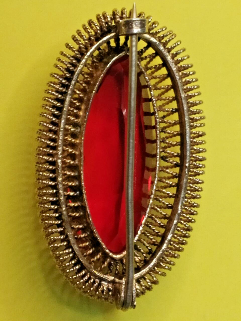 Gilded USSR brooch shown with measuring tape for scale
