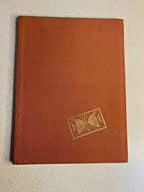 Vintage Soviet stamp collection album with orange cover and hundreds of stamps