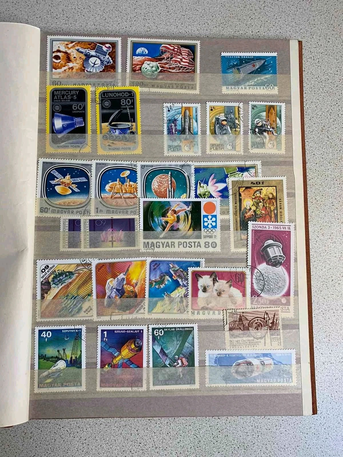 Eastern Bloc stamps arranged behind protective strips on album pages