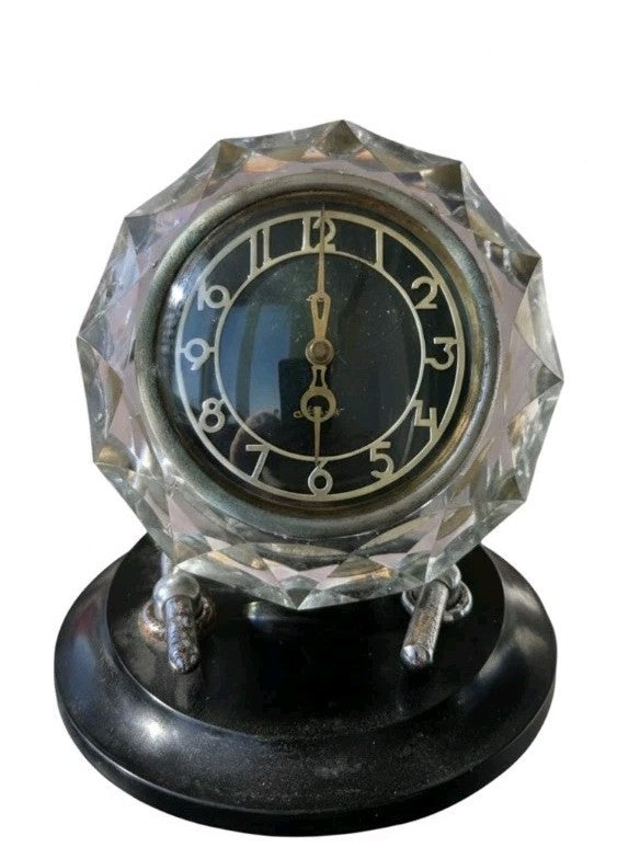 Soviet Mayak table clock with faceted crystal case on a black Bakelite base