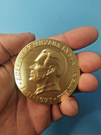 Reverse of Yangel medal with stylized satellite and rocket launch