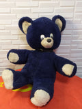 Soviet teddy bear in navy blue plush with cream paws and muzzle and a black collar