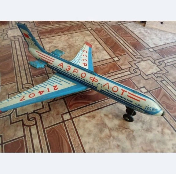 Paint loss and surface rust around the engines of the soviet toy airplane
