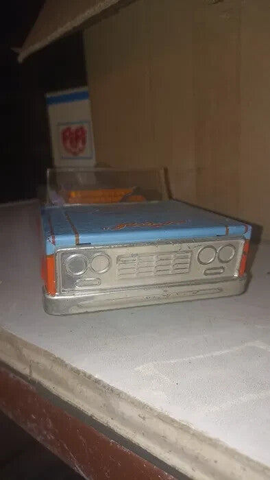 Manufacturer's circular logo on the trunk of the USSR toy car