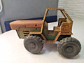 Soviet tin toy tractor in green and yellow pressed steel with open cab