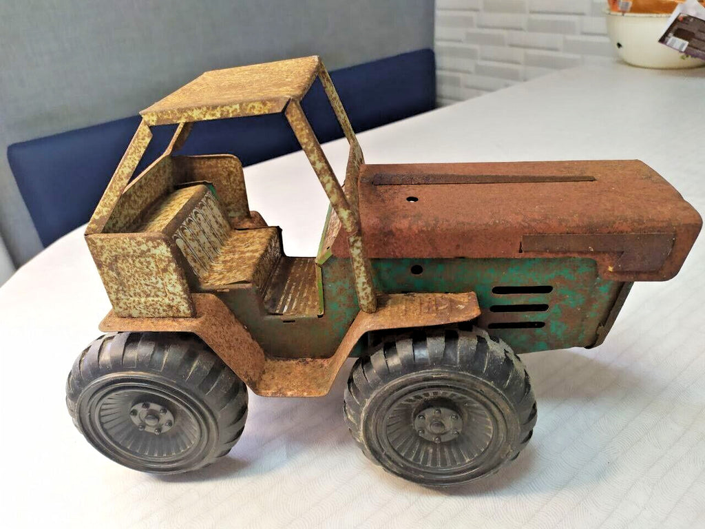 Old Soviet tin toy tractor side view with large rubber tires