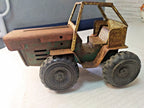 Soviet toy tractor shown with measuring tape for scale