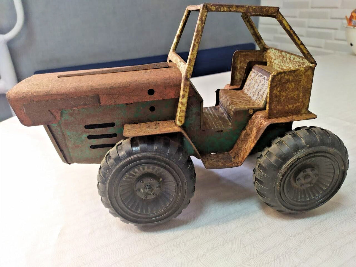 Soviet toy tractor shown with measuring tape for scale