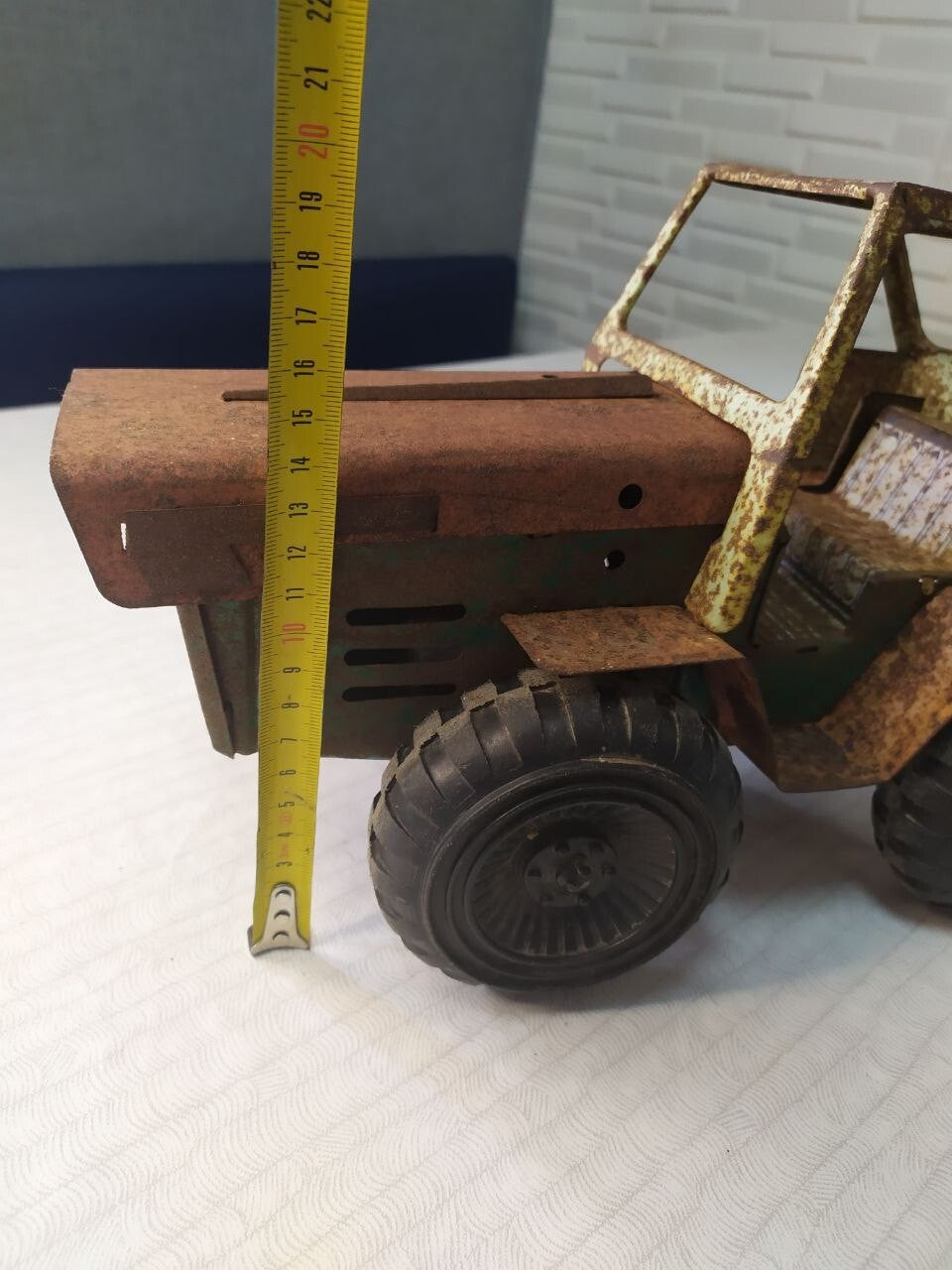 Soviet toy tractor shown with measuring tape for scale – detail 7