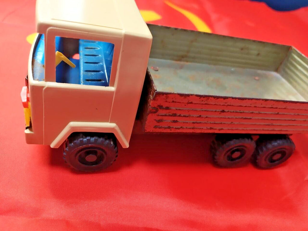 Old Soviet toy truck showing play wear, rust and paint loss on the tin bed