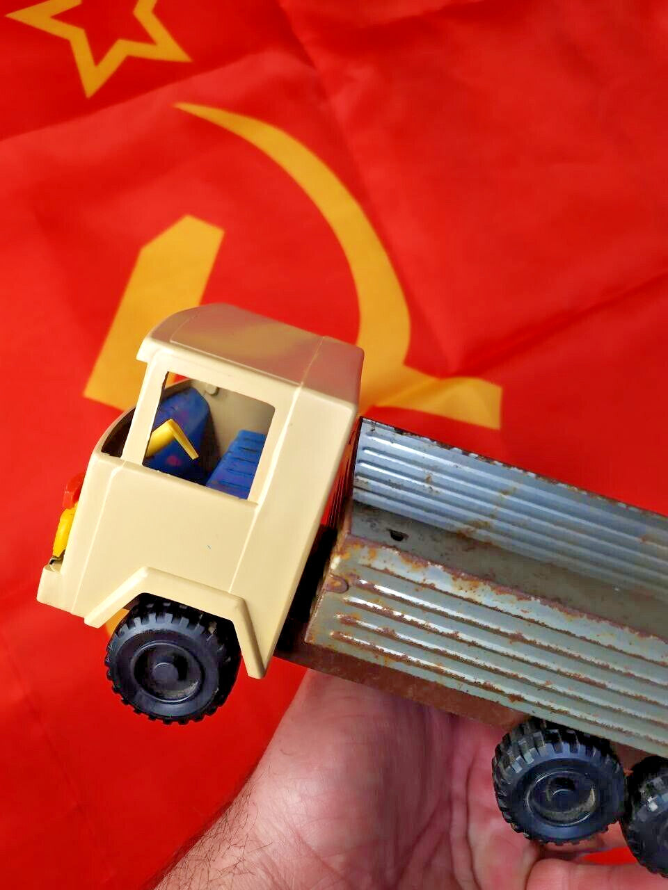 Blue seating and yellow steering wheel inside the USSR toy truck cab