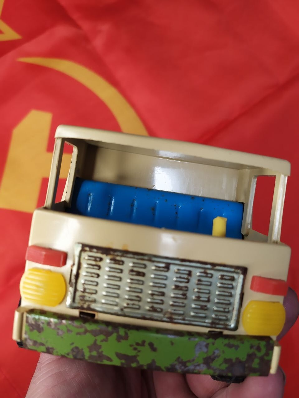 Blue seating and yellow steering wheel inside the USSR toy truck cab – detail 9