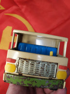 Blue seating and yellow steering wheel inside the USSR toy truck cab – detail 9