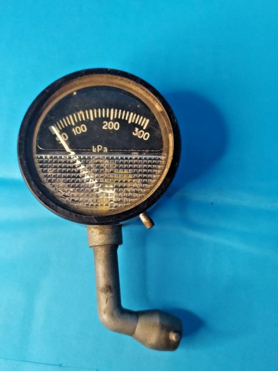 Old Soviet car tool with curved nozzle for classic car trunk