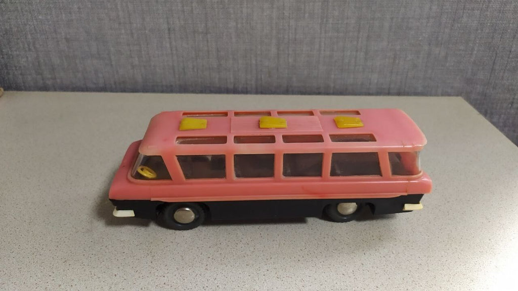 Interior seating visible through the windows of the MIR toy bus