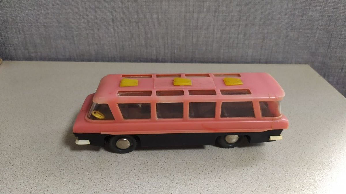 Interior seating visible through the windows of the MIR toy bus
