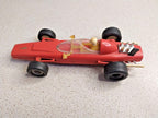 Red plastic Formula 1 toy measured at about 14.5 cm