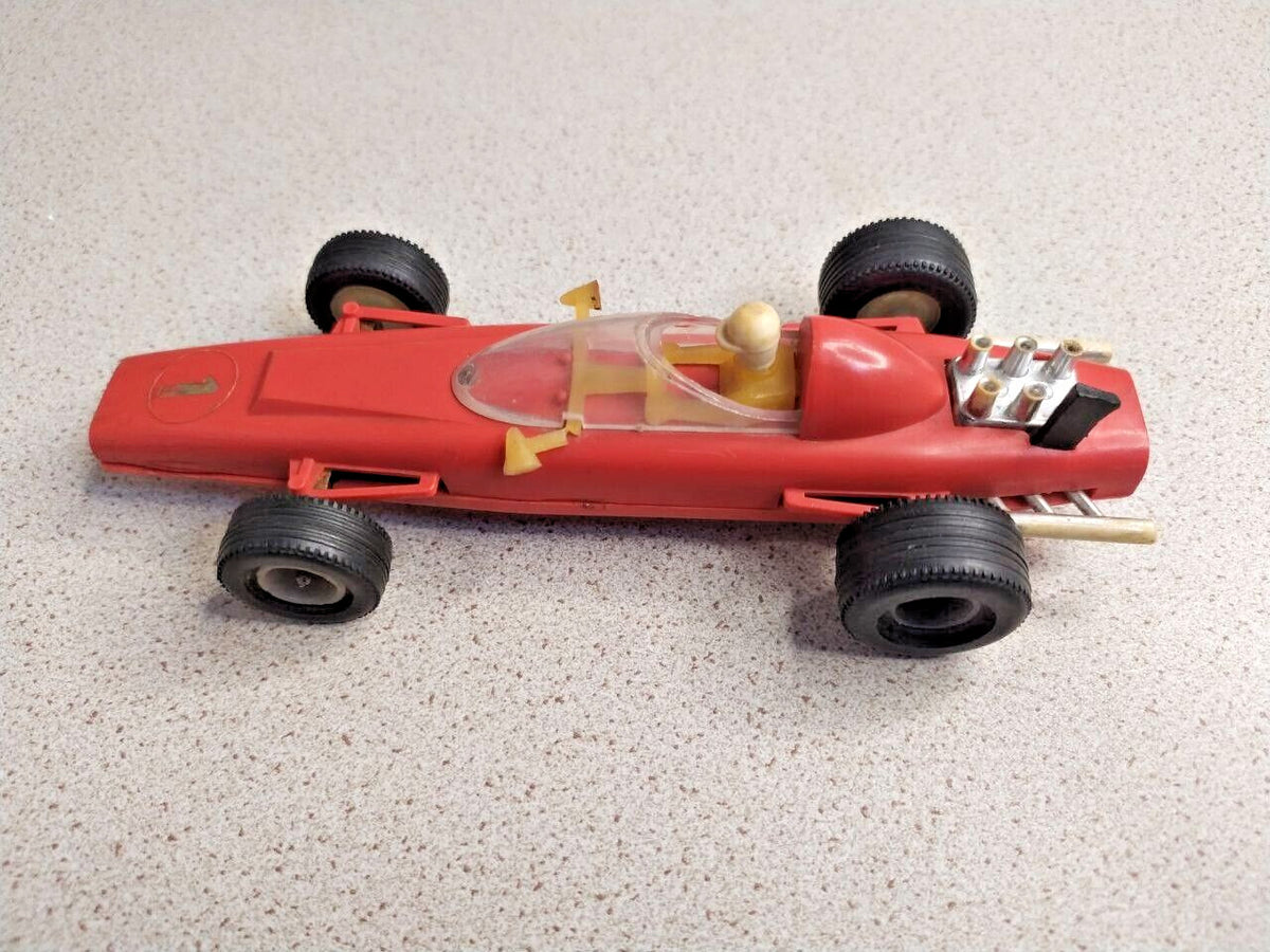 Red plastic Formula 1 toy measured at about 14.5 cm
