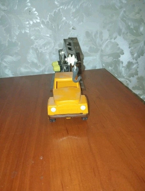Old Soviet toys crane truck side view, yellow cabin and brown body