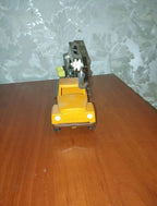 Old Soviet toys crane truck side view, yellow cabin and brown body
