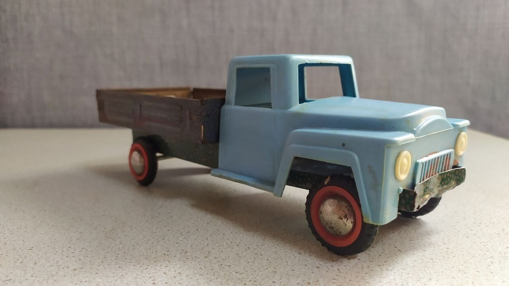 Soviet toy truck in GAZ-53 style with light blue plastic cab and tin cargo bed