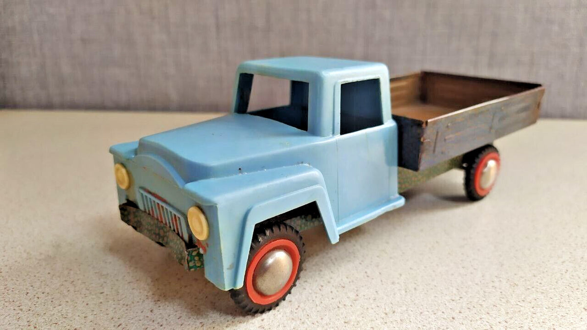 Vintage Soviet toy car with lithographed green pebble-pattern chassis
