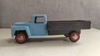 Old Soviet tin toy truck side view showing rolling wheels