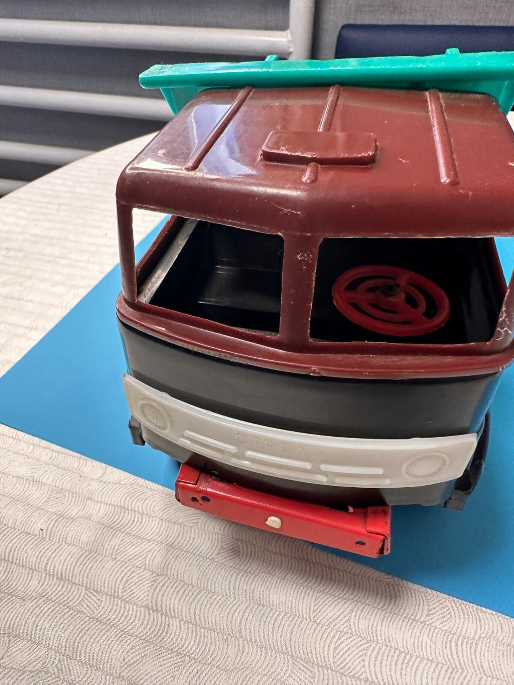 Old Soviet toy dump truck with body raised by hand