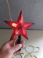 Soviet tree topper shaped as a red Kremlin-style star in translucent ribbed plastic