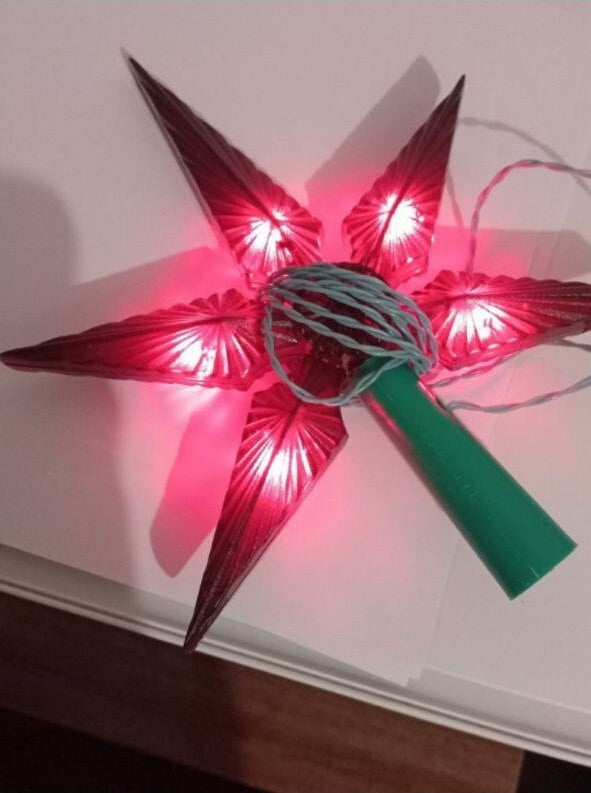Soviet tree topper Zvezdochka 220-5, ruby-red five-point star glowing with the light on