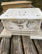 Soviet home decor casket panel with running hares and a snowy cabin