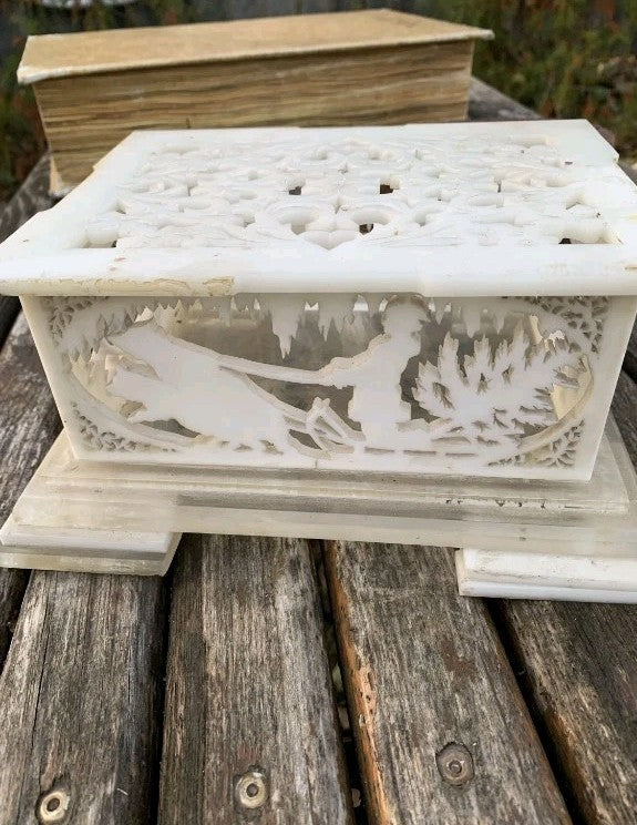 Soviet home decor casket panel with running hares and a snowy cabin