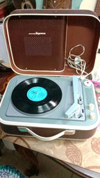Molodezhny record player open showing platter and light blue tonearm