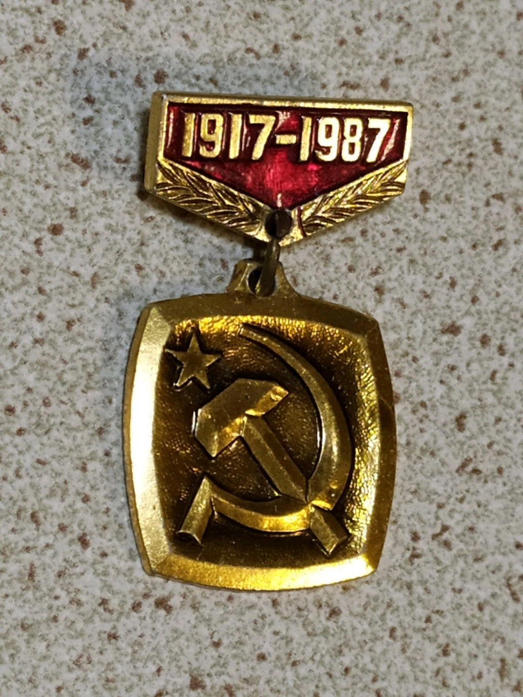 Vintage USSR 70th anniversary badge on plain background