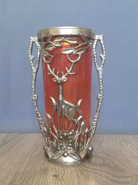 Silver-toned metal relief of a deer among branches with side handles