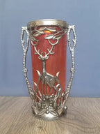 Silver-toned metal relief of a deer among branches with side handles