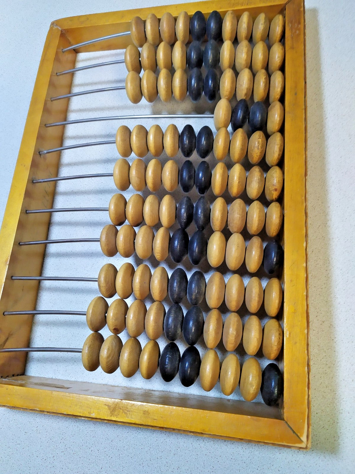 Vintage Soviet abacus, close-up of wooden beads and patina on the frame