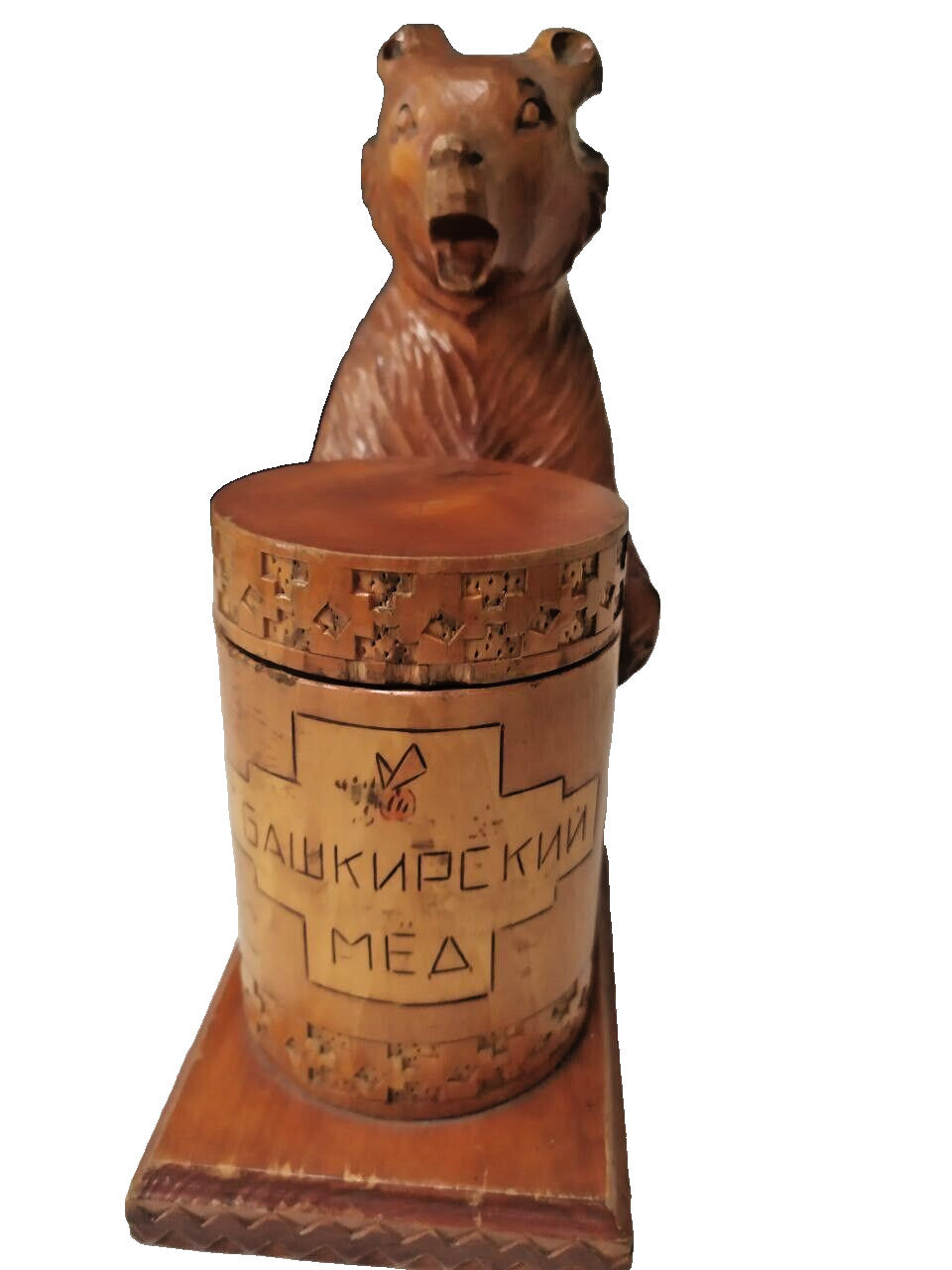 Hand-carved brown bear with textured fur finish on wooden base